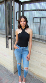 MODEL IN A CRISS CROSS TOP WITH JEANS