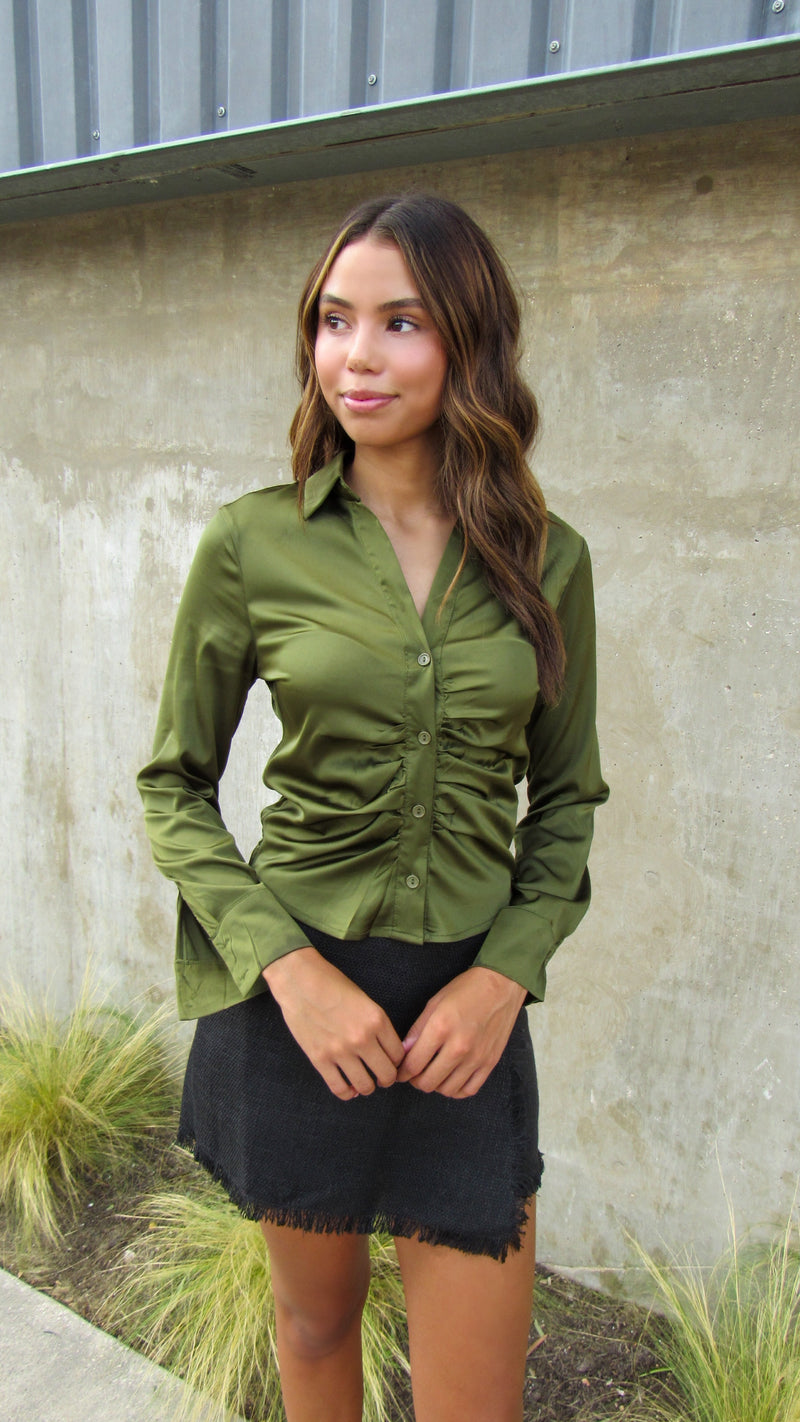 OLIVE SATIN TOP PAIRED WITH A BLACK TWEED SKORT. 
